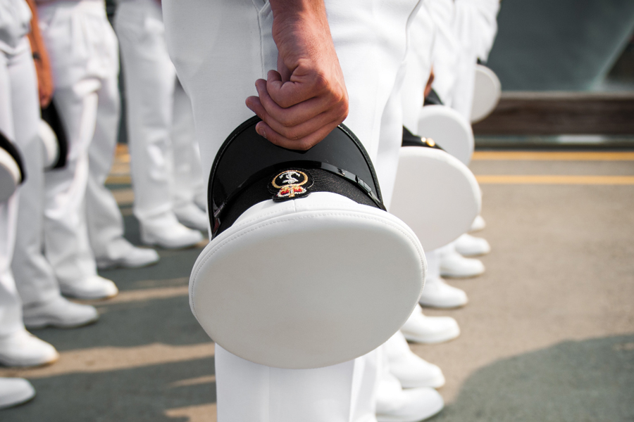 Members of HMCS Saskatoon bow their heads in prayer during the ceremony.