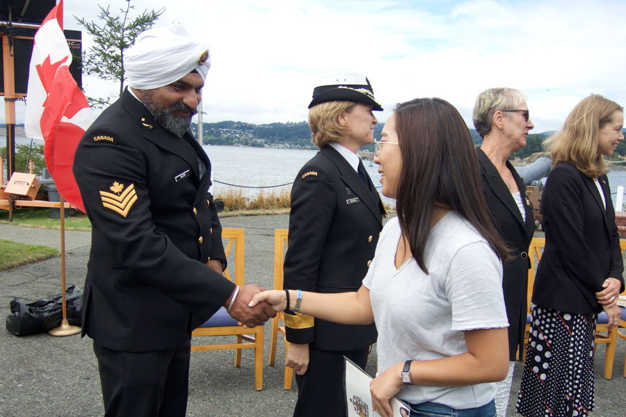 PO2 Kenwar Nijjer, co-chair of the Defence Visible Minority Action Group, congratulates one of 85 new Canadian citizens after receiving their official citizenship certificates. Photos by Peter Mallett, Lookout