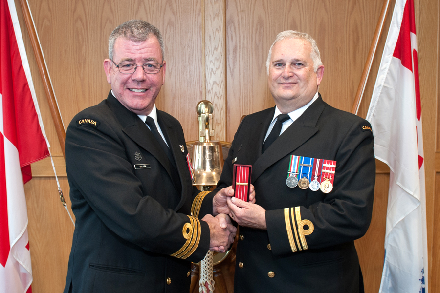 Commander Wes Golden, Commanding Officer of Maritime Forces Pacific (MARPAC) Headquarters, presents Lieutenant Commander Paul Seguna with the third clasp to the Canadian Forces’ Decoration. Photo by Leading Seaman David Gariepy, MARPAC Imaging Services