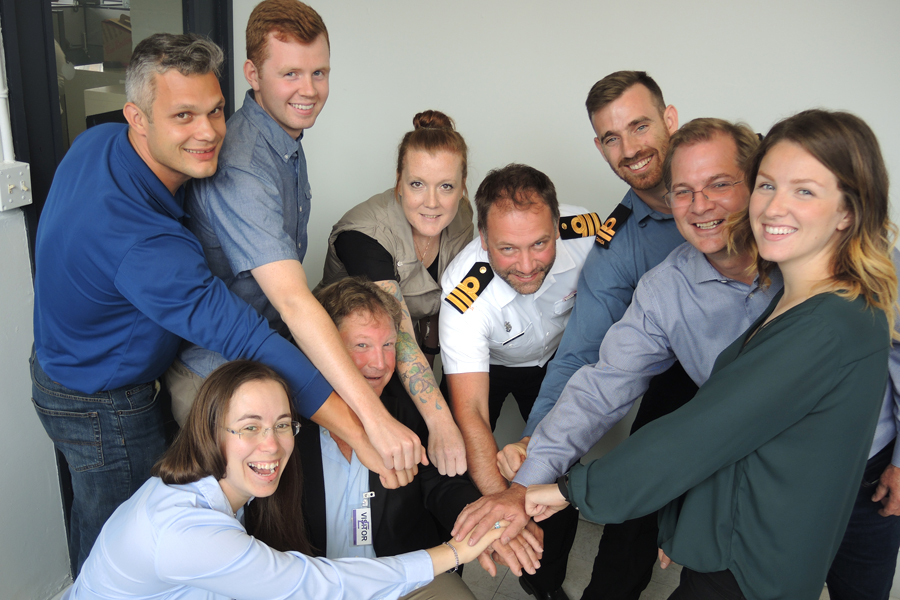 It was all hands on deck for members of HMCS Calgary and HeroWork who came together for a group cheer to celebrate their involvement in an upcoming renovation project at Victoria’s Anawim House. Photo by Peter Mallett, Lookout