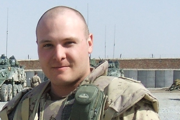 Lt Michael McCauley takes a break from patrol in Panjwayi District of Afghanistan, July 2007. He is the silhouetted soldier on the new Afghanistan Memorial. Credit: File Photo/DND