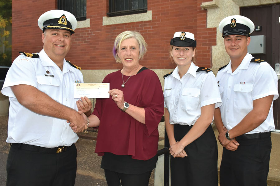 LCdr Collin Forsberg, HMCS Brandon’s Commanding Officer, presents a cheque for $1,100 to Judy Sieb of Food for Thought, a charity that ensures all school children receive a healthy breakfast. Photo Credit: Lori Truscott, CFB Shilo Public Affairs Officer