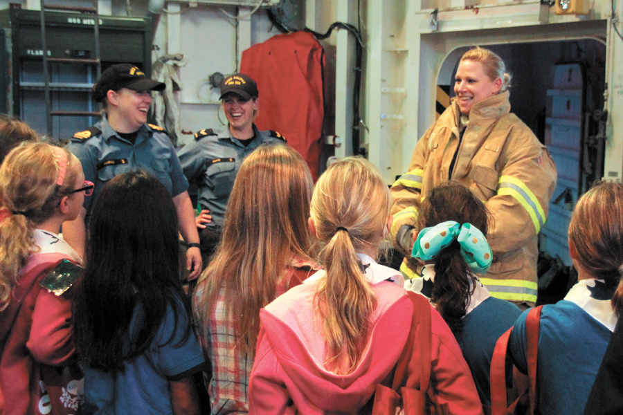 LS Corey Aube from HMCS Halifax talks about some of her firefighting gear with the visiting Girl Guides group. Photos by Ryan Melanson, Trident Staff