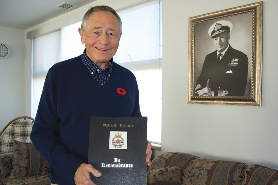 HMCS Venture graduate retired Capt(N) Wilf Lund displays the Venture Book of Remembrance in the Welland Room at Work Point. Photo by Peter Mallett, Lookout Newspaper