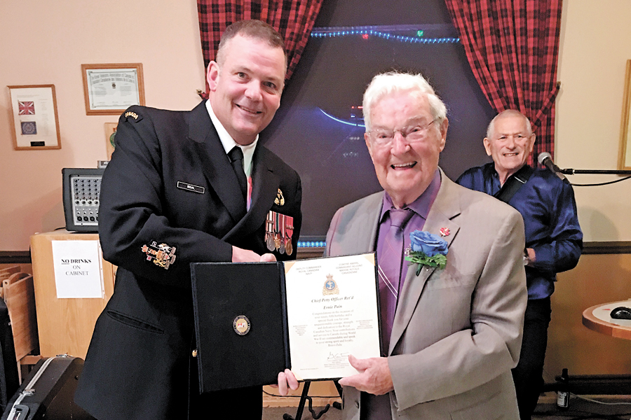 Ernie Pain, right, receives a certificate honouring his 95th birthday and war service from Chief Petty Officer First Class Dave Bisal.