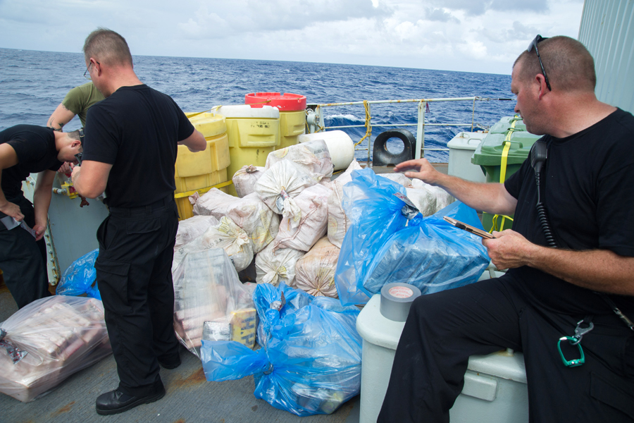 Crewmembers from Her Majesty’s Canadian Ship Moncton mark the drug bundles seized by US Coast Guard members on Nov.11 during Operation Caribbe. Photo by 12 Wing Imaging Services