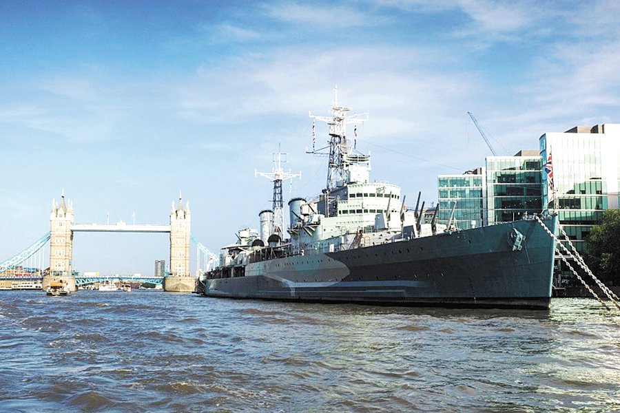 HMS Belfast alongside in the River Thames with Tower Bridge in the background.