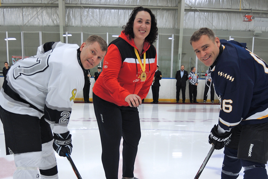Invictus Games 2017 gold medal winner Lt(N) Krista Seguin is joined by Esquimalt Tritons’ Capt(N) Jason Boyd (right) and Comox Flyers’ MCpl Alex Coles for the ceremonial opening puck drop to commence the Men’s Pacific Region Hockey qualifier at the Wurtele Arena Dec. 4. Photo by Peter Mallett, Lookout 