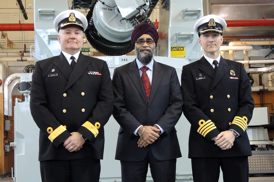 Following a major defence announcement, Minister of National Defence Harjit Sajjan, centre, posed for a photo with Commodore Jeff Zwick (left), Commander Canadian Fleet Pacific, and Captain (Navy) Ed Hooper (right), Commanding Officer Fleet Maintenance Facility, in front of a Close-In Weapons Systems simulator at Naval Fleet School (Pacific). Photo by Peter Mallett, Lookout