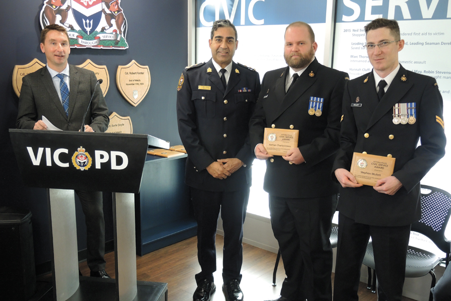 Mark MacIntyre, Victoria Police Department Director of Public Affairs, speaks to those gathered  about the good work of two CFB Esquimalt sailors, Master Seaman Nathan Charbonneau and Leading Seaman Stephon Mullett, after they were presented with a Community Service Award by and Acting Police Chief Del Manak. Peter Mallett, Lookout Newspaper