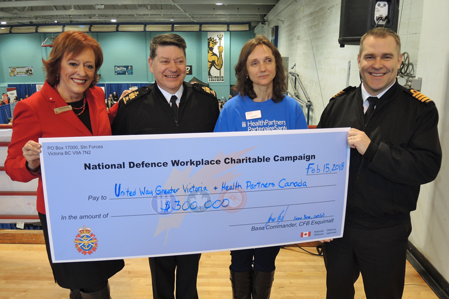 Left: Hazel Braithwaite, United Way of Greater Victoria Director of Community Campaign; Base Chief, Chief Petty Officer Gino Spinelli; Julie Mills, HealthPartners Accounts Manager; and Captain (Navy) Jason Boyd, Base Commander, display a cheque for $300,000 from the National Defence Workplace Charitable Campaign. Photo by Peter Mallett, Lookout