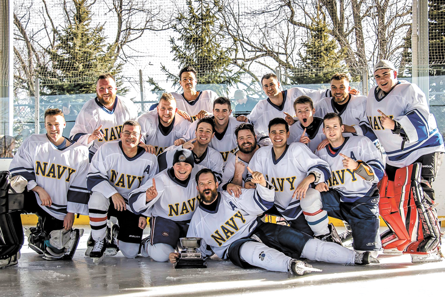 The Navy hockey team from HMCS Hunter celebrates their victory with the Grapes Cup on Jan. 20 while participating in the first of what is to be an annual rivalry matchup between Navy players and Army players in Windsor-Essex county.