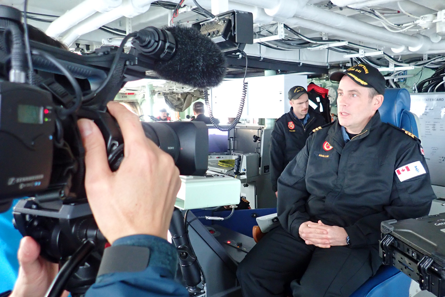 Clement Tang of Chinese-language cable specialty channel Fairchild TV (not pictured) interviews Cdr Alex Barlow, Commanding Officer of HMCS Ottawa, on the ship’s bridge. The TV crew sailed aboard the frigate to get an up-close look at life in the navy. Photos courtesy Fairchild TV