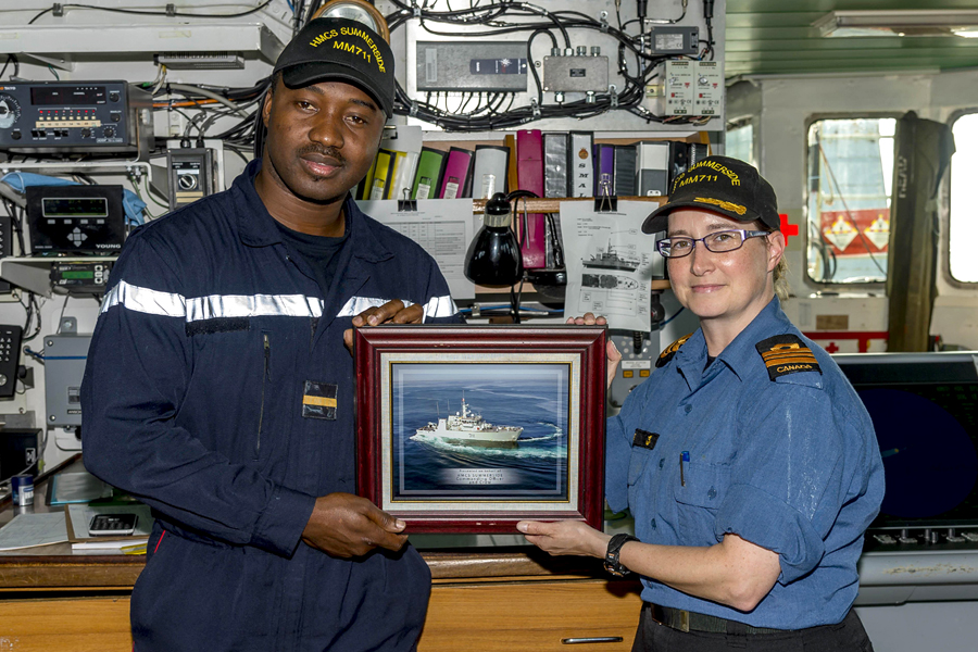 Sub-Lieutenant Lassina Traoré, left, a member of the Ivory Coast Navy, receives a framed photograph of HMCS Summerside from Commanding Officer Lieutenant-Commander Emily Lambert, to remind him of his time as an exchange officer aboard the ship. Photo by OS John Iglesias