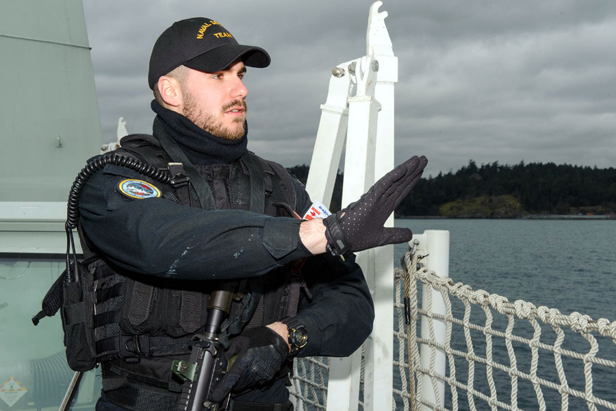 Able Seaman Alex Gauthier, a member of the Naval Security Team, stands sentry watch. Photo by Corporal Blaine Sewell, MARPAC Imaging Services