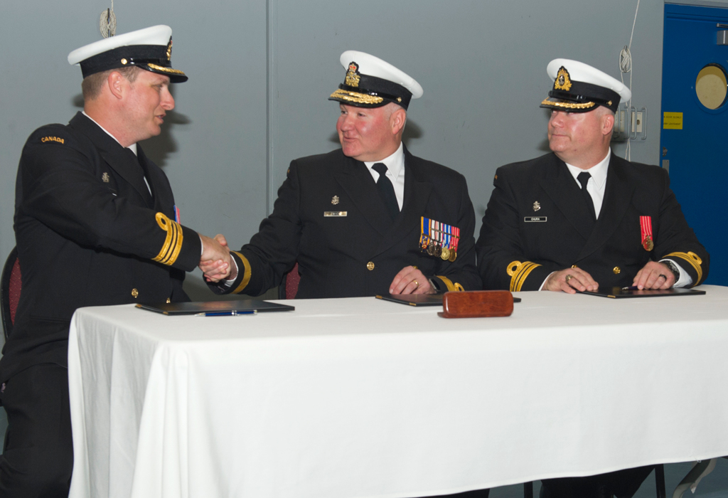 Commanding Officer of the Naval Security Team, Lieutenant Commander Michael Wills (left), is congratulated by Commander Canadian Fleet Pacific, Commodore Jeff Zwick (centre) during a Change of Command Ceremony on May 11. LCdr Wills took command of the unit from LCdr Jeff Chura (right). Photo by LS Ogle Henry, MARPAC Imaging Services