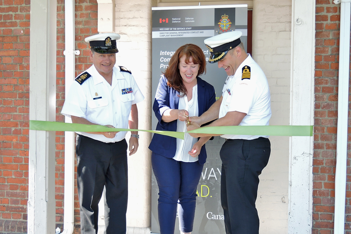 From left: Chief Petty Officer First Class Gino Spinelli, Base Chief; Alison Arnesen, Conflict and Complaint Management Services Regional Manager; Captain (Navy) Jason Boyd, Base Commander, snip the ribbon to officially open the Conflict and Complaint Management Service Centre on June 4. Photo by LS Alex Ilareguy, Lookout