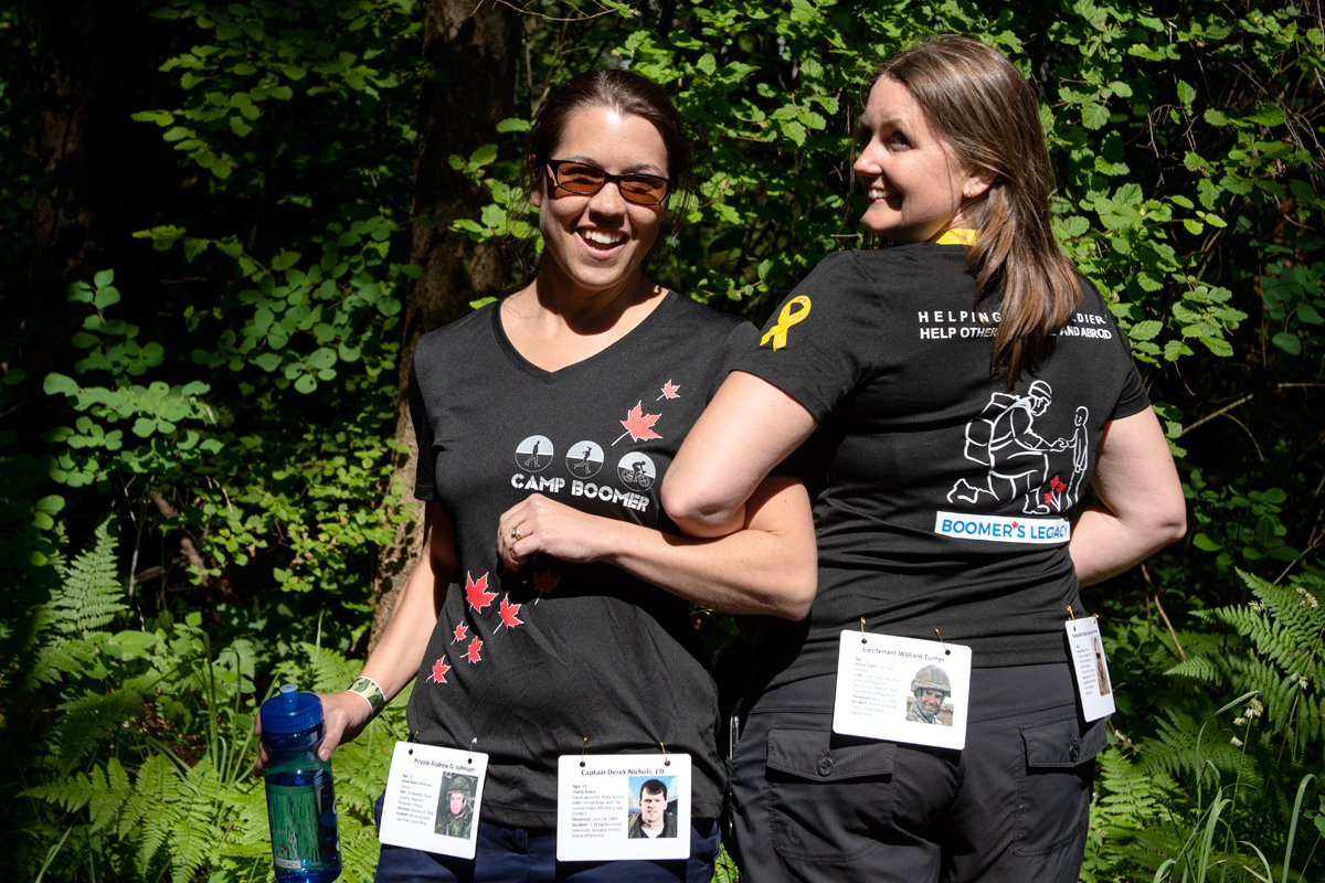 Camille Douglas, Friends of Boomer’s Legacy BC PR/ communications, joins Christine Meyer, Senior Manager Strategic Communications, Corporate Services Division, Canadian Forces Morale and Welfare Services, on the walk/ run circuit at Camp Boomer. The pair had been working together for Boomer’s Legacy - this was their first time meeting in person. They are carrying fallen soldier bio cards. Photo by John’s Photography
