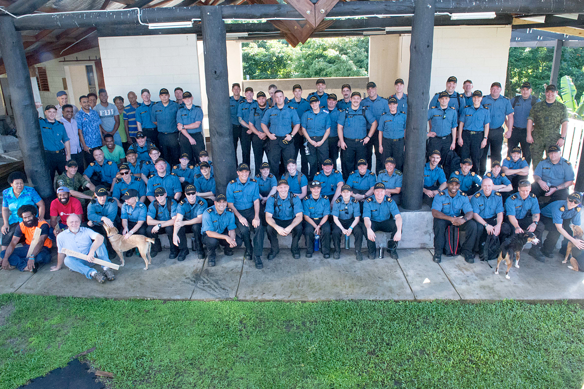 Over 60 volunteers from the ship’s company gather for a photo at the Homes for Hope campus, as they get ready to work on landscaping, renovation and painting projects at the Fiji charity.