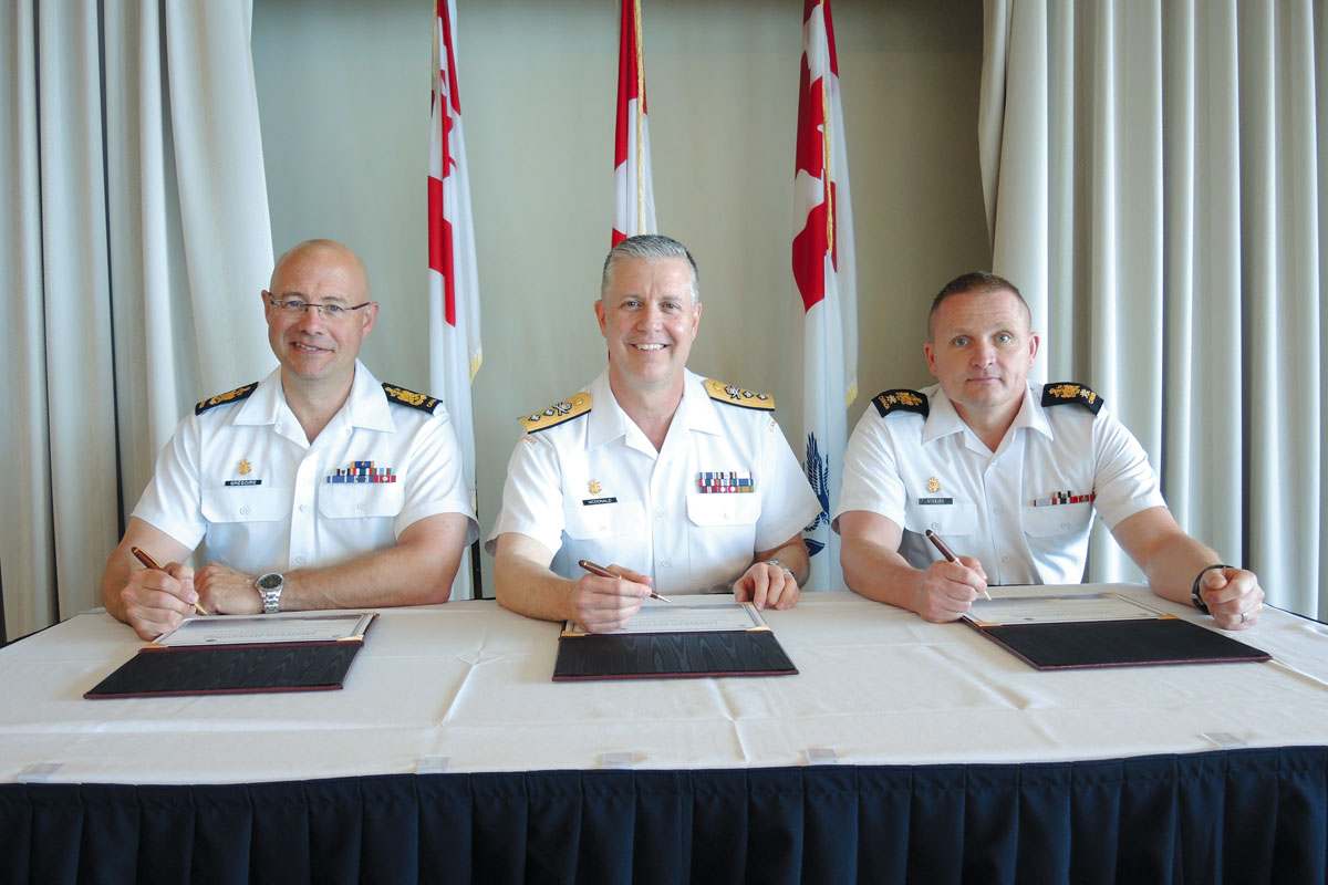 Left to right: Outgoing Formation Chief, CPO1 Gilles Gregoire; Rear-Admiral Art McDonald, Commander Maritime Forces Pacific; and Incoming Formation Chief, CPO1 Dave Steeves, sign the certificates during a Change of Appointment ceremony at the Chiefs’ and Petty Officer’s Mess on May 31. Photo by Peter Mallett, Lookout