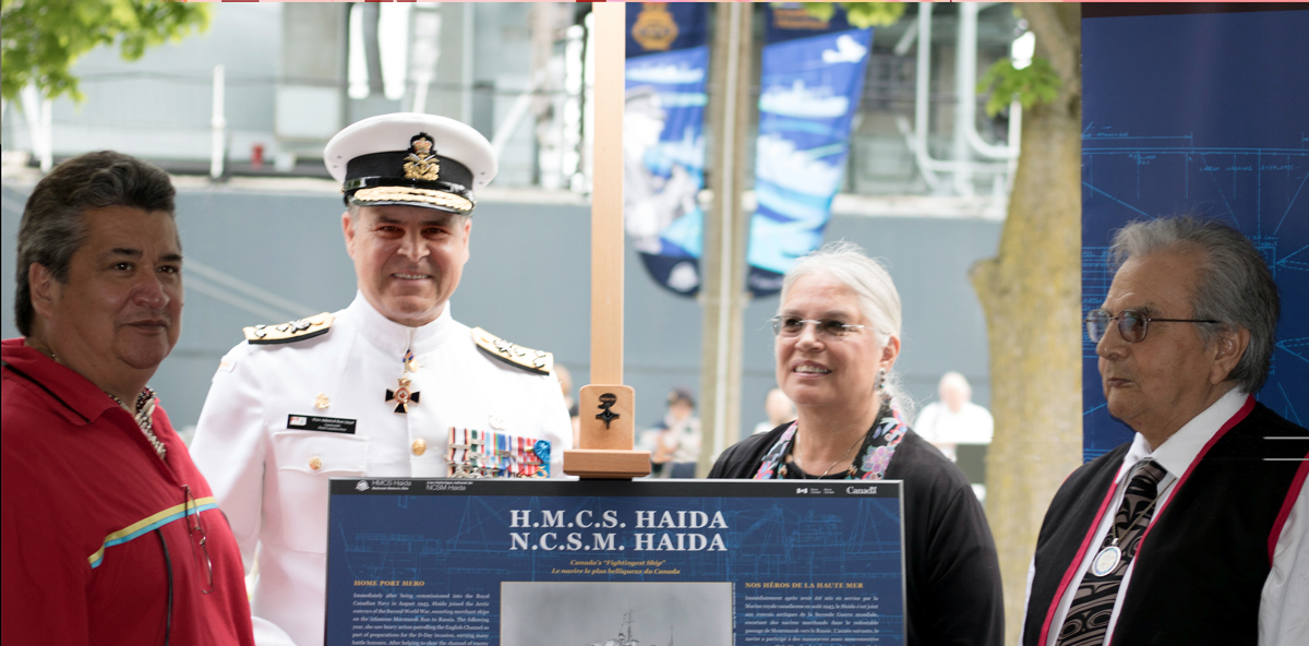 Vice-Admiral Ron Lloyd, Commander RCN, stands together with Chief R. Stacey Laforme, left, Chief Ava Hill, second from right, and Chief Frank Collison during a special ceremony that saw HMCS Haida commissioned as flagship of the RCN.