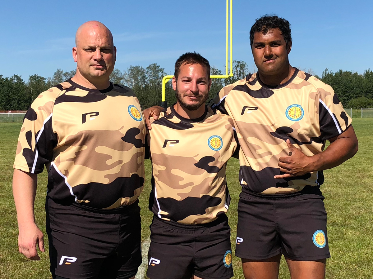 Rugby players from the base, Petty Officer First Class Jay Jimmo, Petty Officer Second Class Marc-Andre Bibeau, and Leading Seaman Lionel Achari recently participated in a match against the British Royal Air Force. Photo by LS Derek Rowland