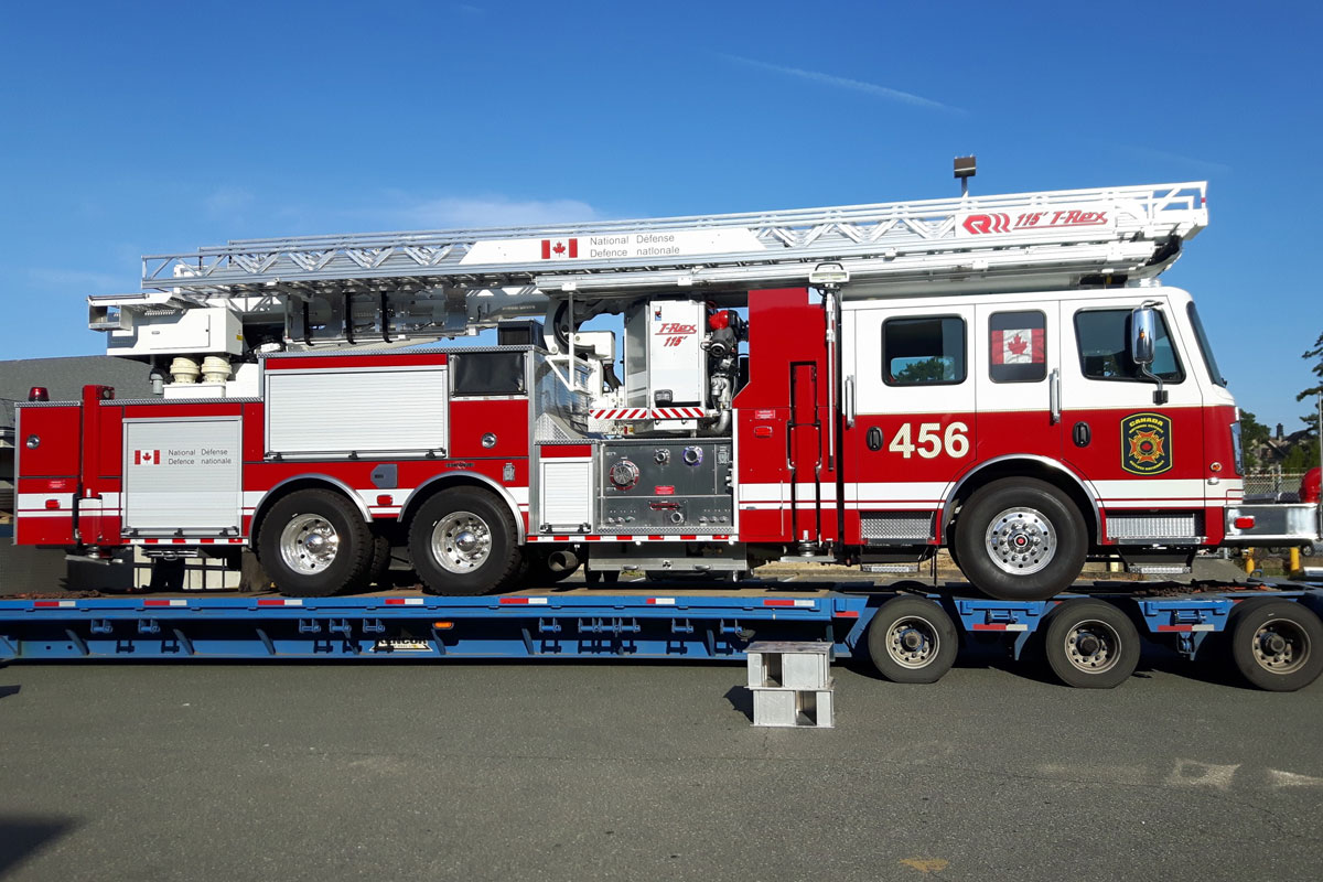 The new Aerial Ladder Fire Fighting Vehicle is unloaded from a transport truck at CFB Esquimalt’s Transport Electrical and Mechanical Engineering (TEME). The new apparatus is one of nine fire trucks being delivered to bases across the country this year. Photo Credit: CFB Esquimalt Fire and Rescue
