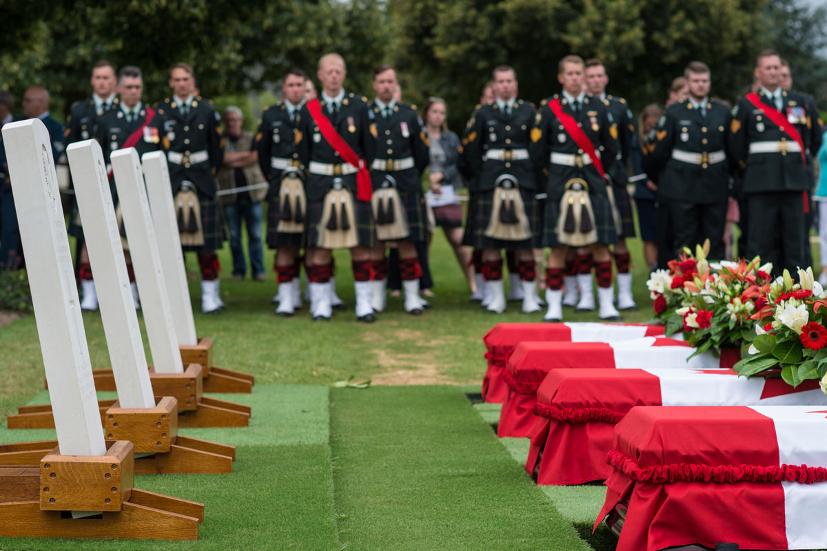 Soldiers from the Canadian Scottish Regiment of Victoria and the Royal New Brunswick Regiment of Fredericton stand at ease alongside the final resting place of four Canadian First World War soldiers who died at the Battle of Hill 70. Photos by MCpl True-dee McCarthy, CF Combat Camera