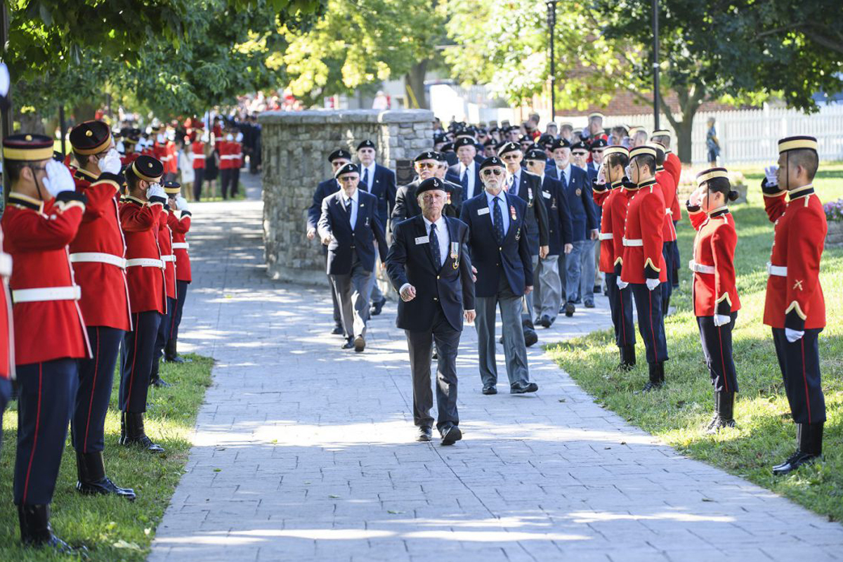 Members of the Royal Military College (RMC) Old Brigade and Ex-Cadets march from the RMC parade square through a line of RMC Officer Cadets to the Memorial Arch for a remembrance ceremony. Photo by Steven McQuaid