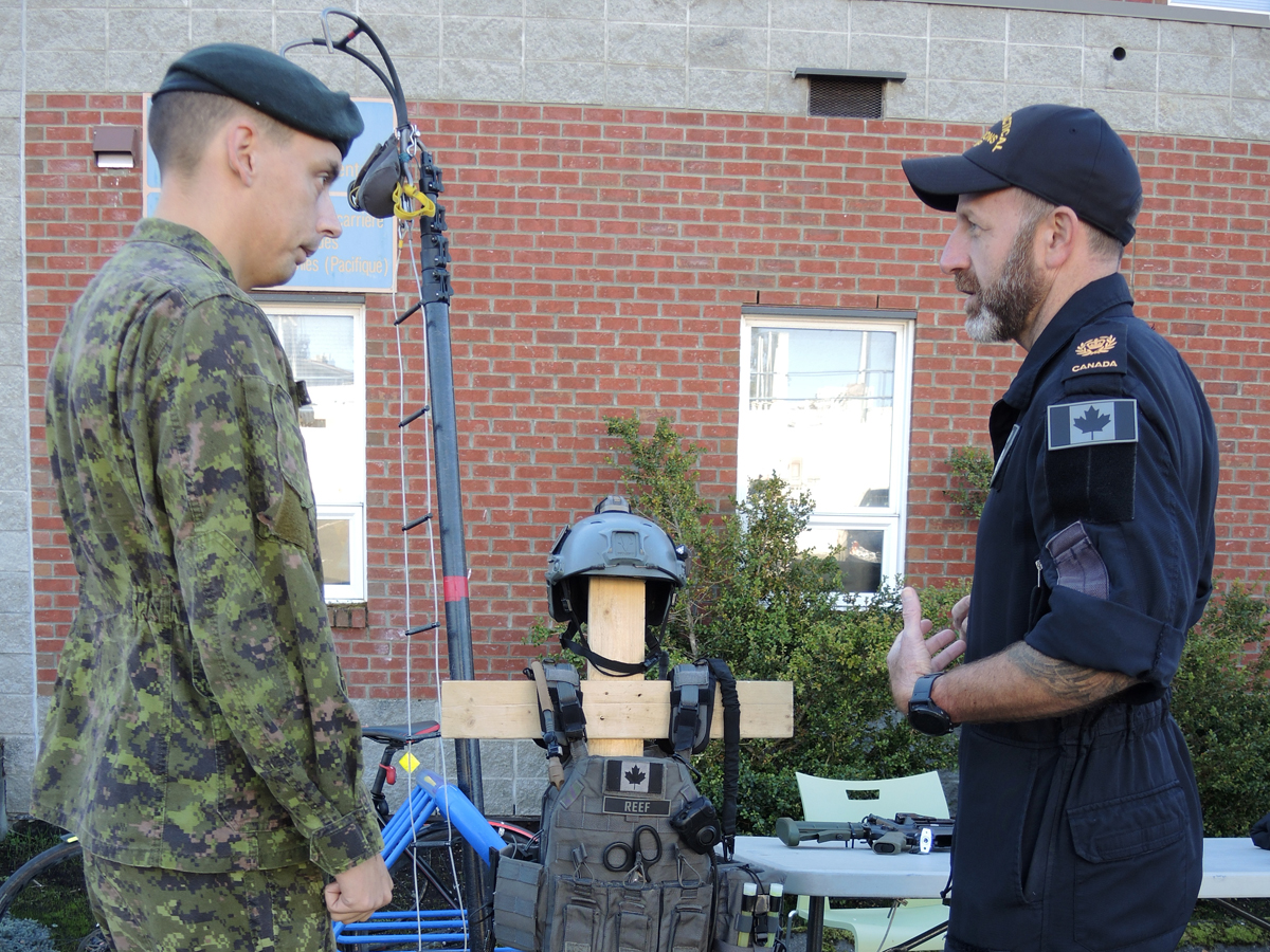 Corporal Ryan Cunningham of Base Logistics speaks with a member of the Naval Tactical Operations Group during the Canada Defence Team Career Networking Fair on Oct. 17. CFB Esquimalt was one of seven military bases across Canada to participate in the first annual career networking fair. Photo by Peter Mallett, Lookout