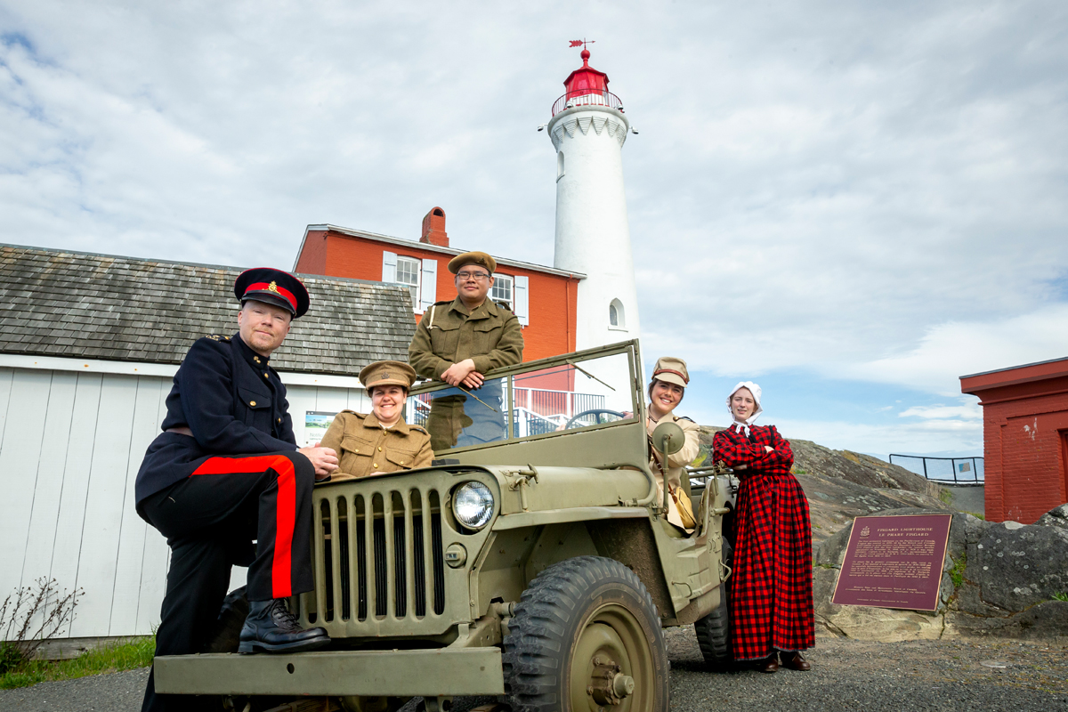 Fort Rodd Hill and Fisgard Lighthouse National Historic Sites interpreters in a 1942 Willys Jeep, in front of Fisgard Lighthouse. Photo by Fritz Mueller, Parks Canada