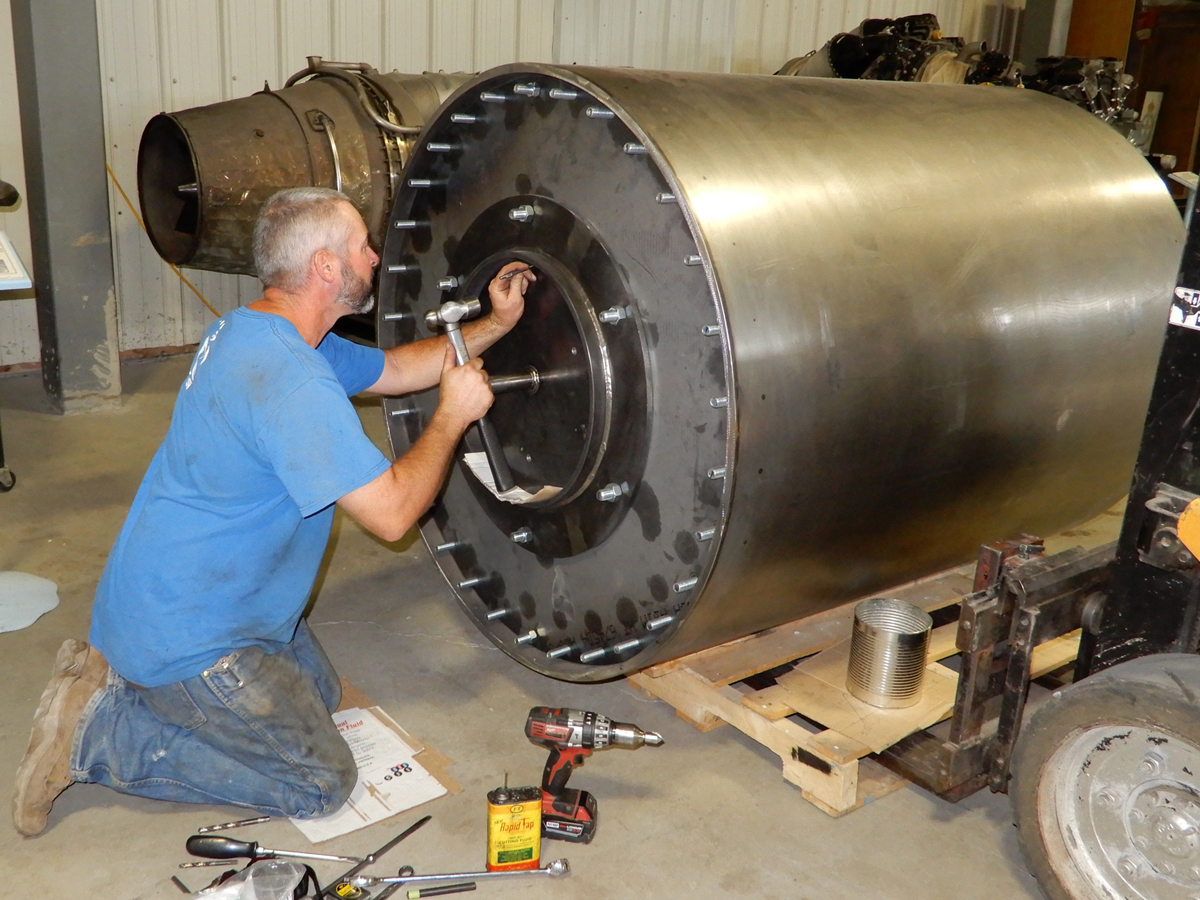 Multi-talented craftsman volunteer, Ben Schwartz, puts the finishing touches to the bouncing bomb replica at the Bomber Command Museum of Canada in Nanton, Alberta. Schwartz also designed and built the mounts for the bomb on the museum’s Lancaster. Photo by John Chalmers