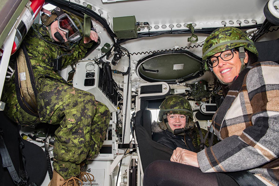 Honorary Lieutenant-Colonel, for the day, Aiden Anderson, along with his sister Courtney Holland and mother Isabella Anderson, experienced army equipment during their visit to Le Régiment de Hull (RCAC), in Gatineau, Quebec, on Dec. 13. Photo by Jay Rankin, Canadian Army Public Affairs