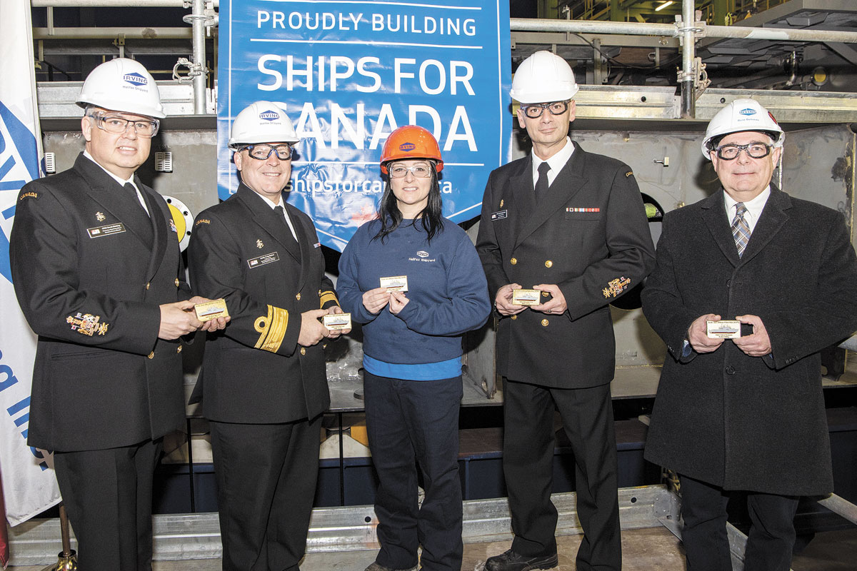 From left: CPO1 Derek Kitching, Atlantic Fleet Chief; RAdm Craig Baines, Commander Maritime Forces Atlantic; Irving Shipbuilding employee Vicki Berg; CPO1 Sylvain Jaquemot, Pacific Fleet Chief, and Rene Belliveau, Irving Shipbuilding VP, Production, at the keel-laying ceremony on Dec. 6, 2018, with a plaque as a memento. Photo by Mona Ghiz, Marlant PA