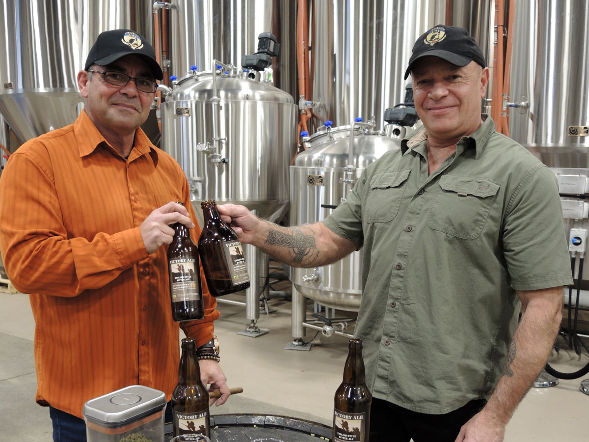 Captain (Retired) Graeme Hafey and Master Corporal (Retired) John Bowker raise a toast celebrating the launch of their company V2V Black Hops Brewing Company at Victoria’s Caledonia Brewery Distillery. 