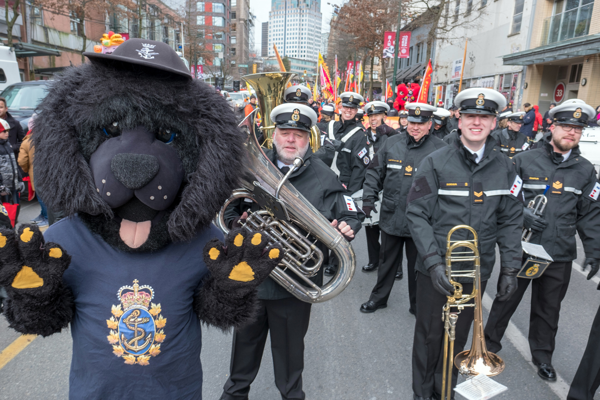 Sonar the Royal Canadian Navy mascot checks in with the Naden Band of the Royal Canadian Navy prior to the parade start. Photo by PO2 Greg Matthews