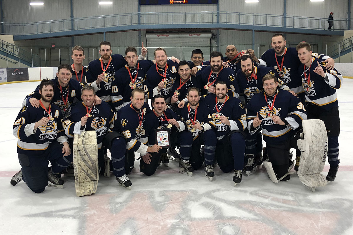 Members of the CFB Esquimalt Tritons gather for a victory photograph following their 5-4 win over CFB Edmonton in the championship game of the Canada West Regional hockey tournament in Wainwright, AB, on Feb. 1.