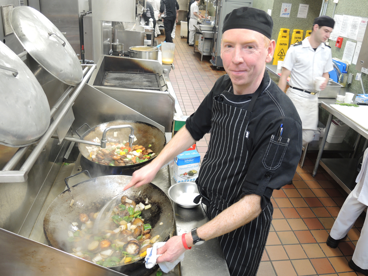 LS Robbie McDougall of Base Foods showcases his special cod fillet meal in the kitchen at Nelles Block. Photo by Peter Mallett, Lookout