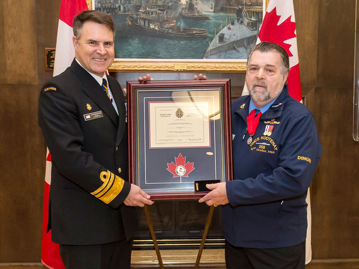 AB (Retired) Allan “Dinger” Bell, a survivor of the 1969 HMCS Kootenay explosion, was presented the Wound Stripe on by VAdm Ron Lloyd, Commander Royal Canadian Navy. Photo by AB John Iglesias, FIS