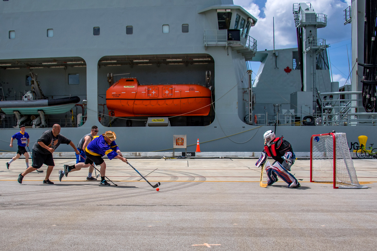 Members of the HMCS Regina and NRU Asterix’s crews play a game of ball hockey during some down time during Operation Projecton on Naval Base Guam in Guam, United States Of America during Operation Projecton on March 7. Photo by Corporal Stuart Evans, Borden Imaging Services