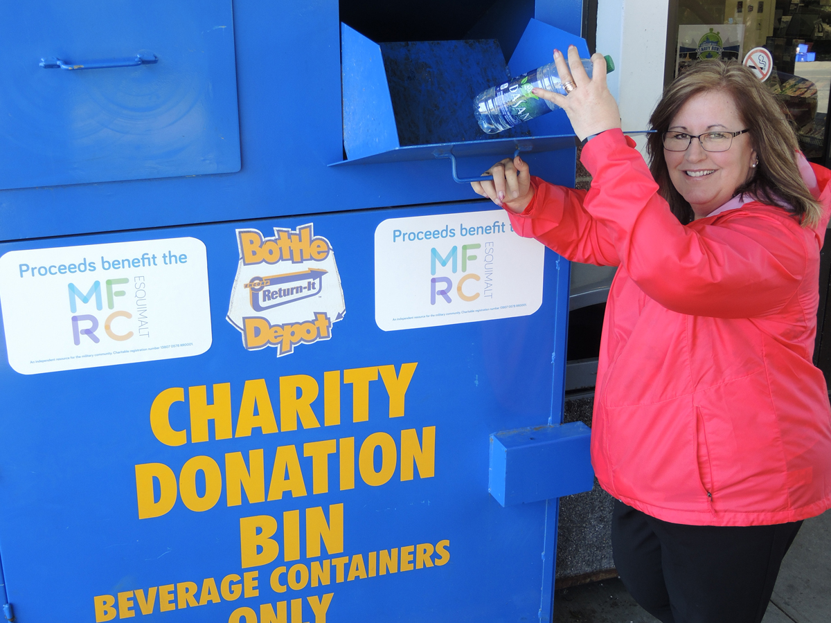 Lisa Church, Military Family Resource Centre (MFRC) Esquimalt Community Engagement Manager, drops a beverage container into the new Bottle Depot community donation bin at the CANEX convenience store in Colwood. Proceeds from donations will go to support the MFRC’s deployment programs. Photo by Peter Mallett, Lookout