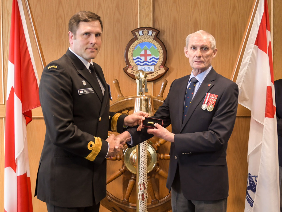 Cmdre Angus Topshee presents Cdr (Retired) Al Kennedy with athe Wound Stripe on May 14. Kennedy was severely injured in the HMCS Kootenay explosion on Oct. 23, 1969. Photo by SLt Michael Déry
