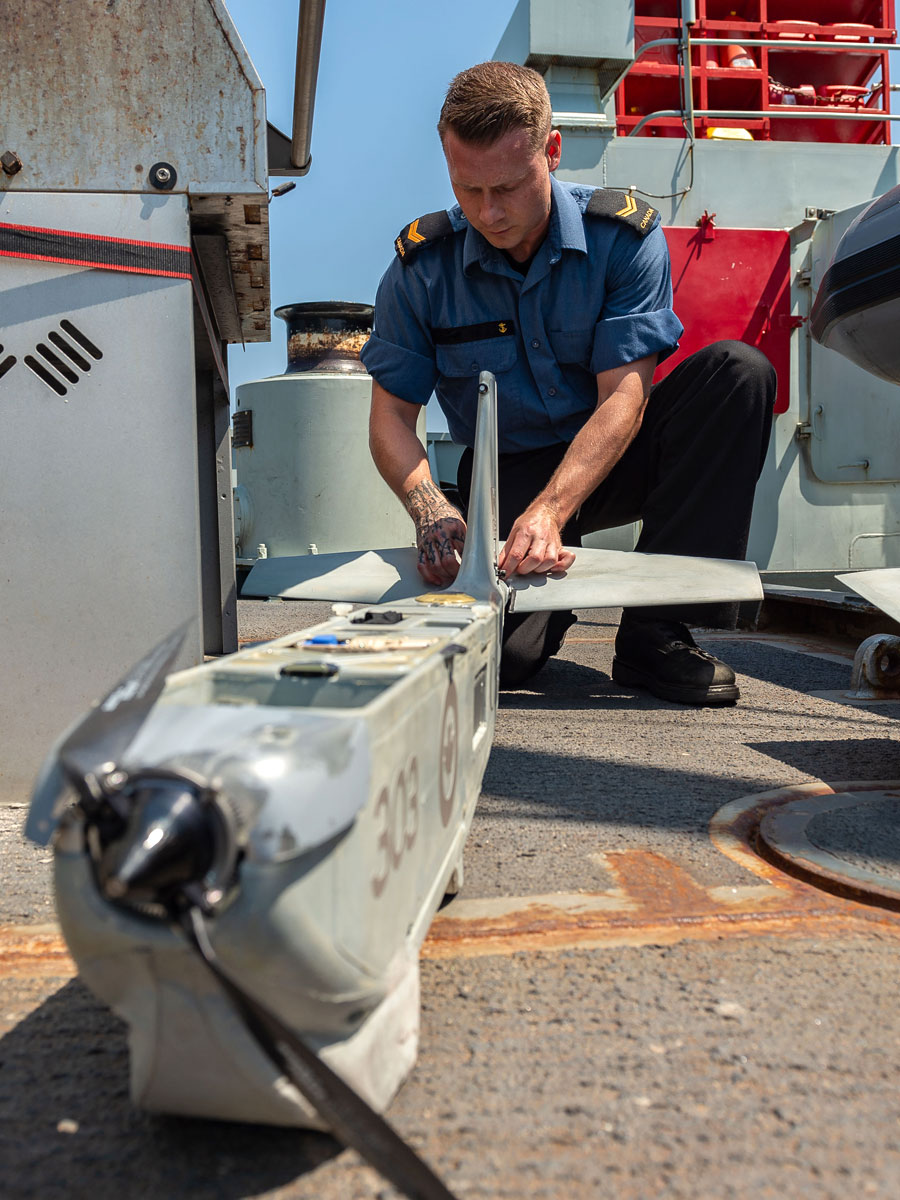 An unmanned aerial vehicle (UAV) controller assembles the UAV onboard HMCS Whitehorse during Operation Caribbe. Photos by Operation Caribbe Imagery Technician