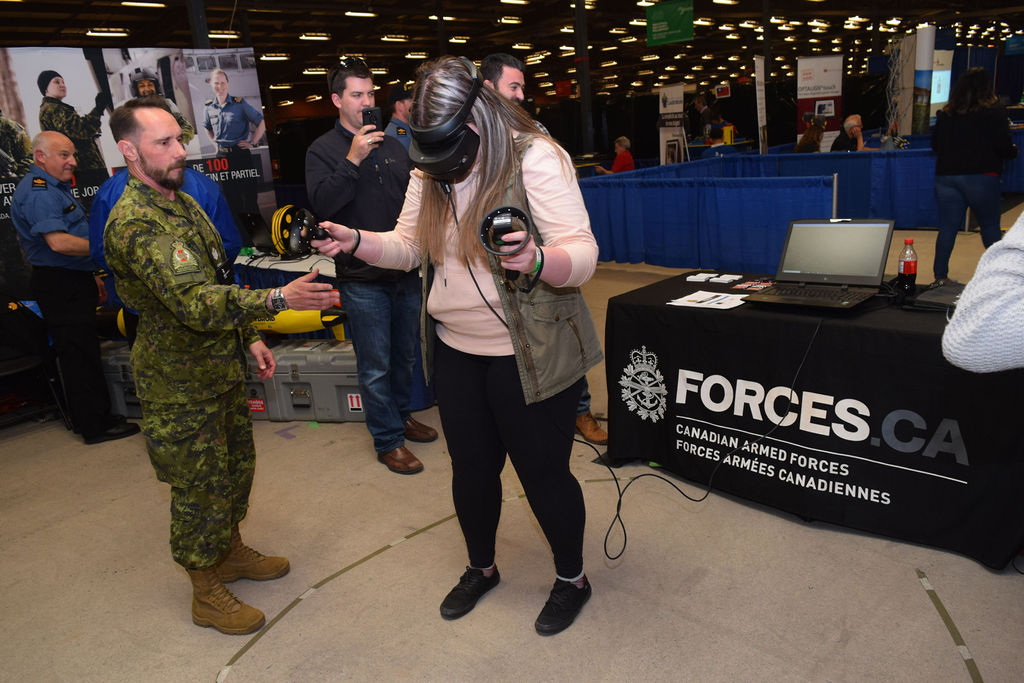 Sgt Tim Keith from CFRC assists a student as she experiences the CAF through virtual reality. This was one of many skilled trades and technology activities available at the 2019 Skills Canada National Competition, held May 28 and 29 at the Halifax Exhibition Centre. Photo by Sgt Dianne Lambert, CFRC Atlantic