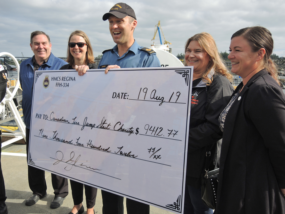 MS Jeffrey Haines of HMCS Regina presents a cheque for $9,412 to representatives from Canadian Tire’s charity Jumpstart on Aug. 19 in Dockyard. MS Haines raised the money by performing hundreds of haircuts during his ship’s six-and-a-half month deployment.