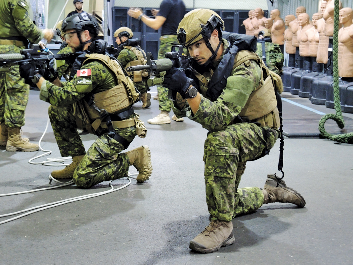 Clearance divers practice an all-around defensive posture with C8 carbine rifles in preparation for a multi-national training exercise with the U.S. Marines in Guam later this month. Photo by Peter Mallett, Lookout