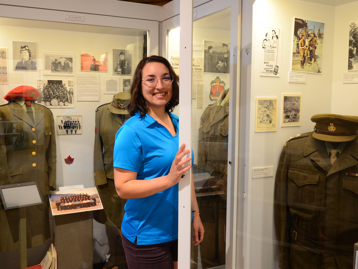 Marina Craig, Vernon Cadet Museum Director of Marketing and Operations, makes a final check on one of the many displays of uniforms before the re-opening of the Vernon Cadet Museum for the summer.