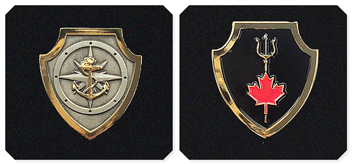 Badge 1 (left): The Naval Boarding Party Basic Qualification badge is a silver shield bordered by gold trim three centimetres in height. A stylized naval compass is centred on the shield in the background with a gold fouled anchor centred on top of the compass. Badge 2 (right): The NTOQ badge is a black shield encased in gold trim three centimetres in height. A gold trident is centred in the background with a red maple leaf centred on the staff of the trident. Photos by DND