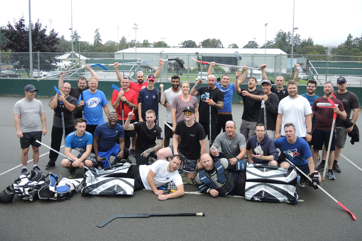 Ball hockey players gather for a celebratory group photo following the conclusion of their game. Photo by Peter Mallett/Lookout