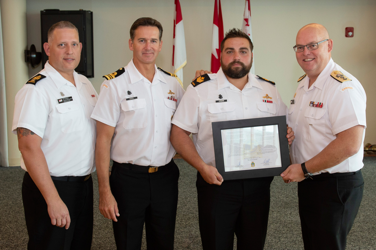 Petty Officer Second Class Benoit Leonard  is introduced to the Chiefs’ and Petty Officers’ Mess and presented with the certificate of Duties and Responsibilities by Chief Petty Officer First Class Tim Blonde, Maritime Forces Pacific (MARPAC) Formation Chief Petty Officer (left), Lieutenant-Commander Richard Kappel, Commanding Officer of Fleet Diving Unit Pacific, and Rear-Admiral Bob Auchterlonie, Commander MARPAC. Photos by Leading Seaman Mike Goluboff, MAPAC Imaging Services
